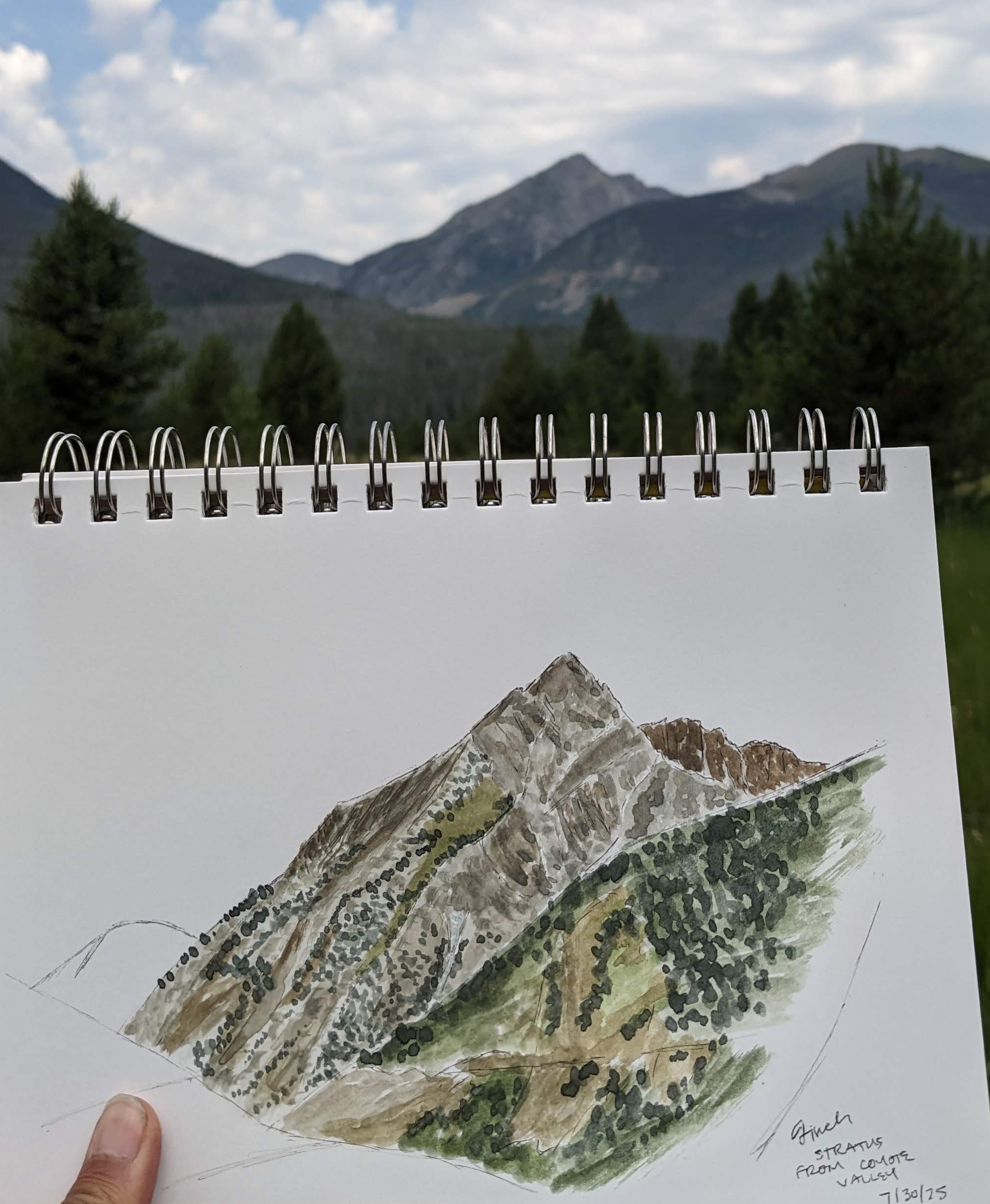 Watercolor with pen outlines of mountain in foreground, mountain in background.
