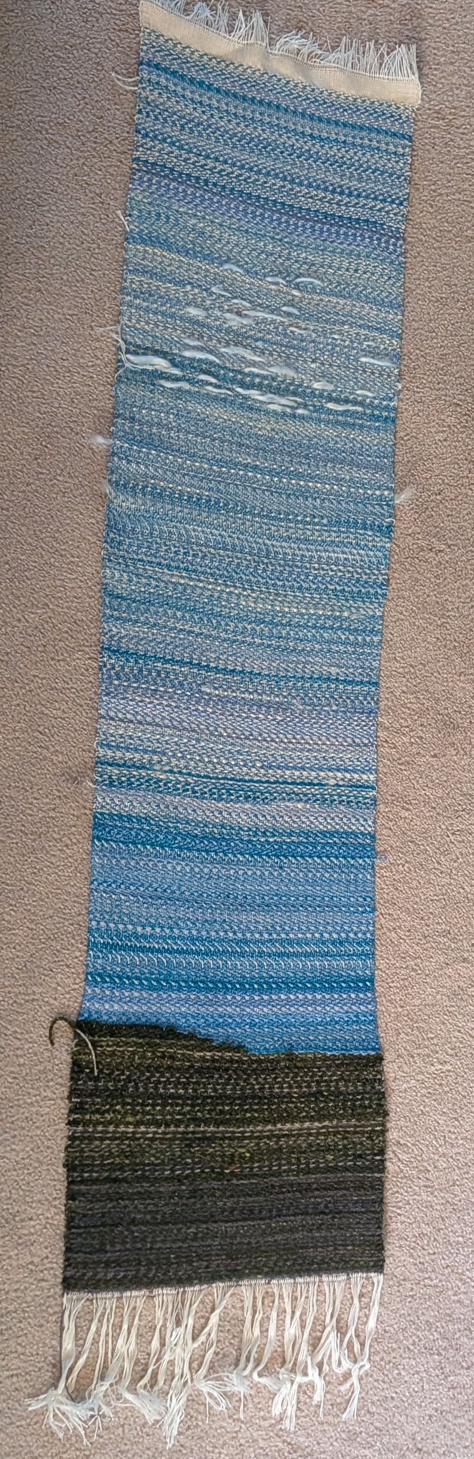 a long panel, mainly blue with vague stripes, and a dark green bottom